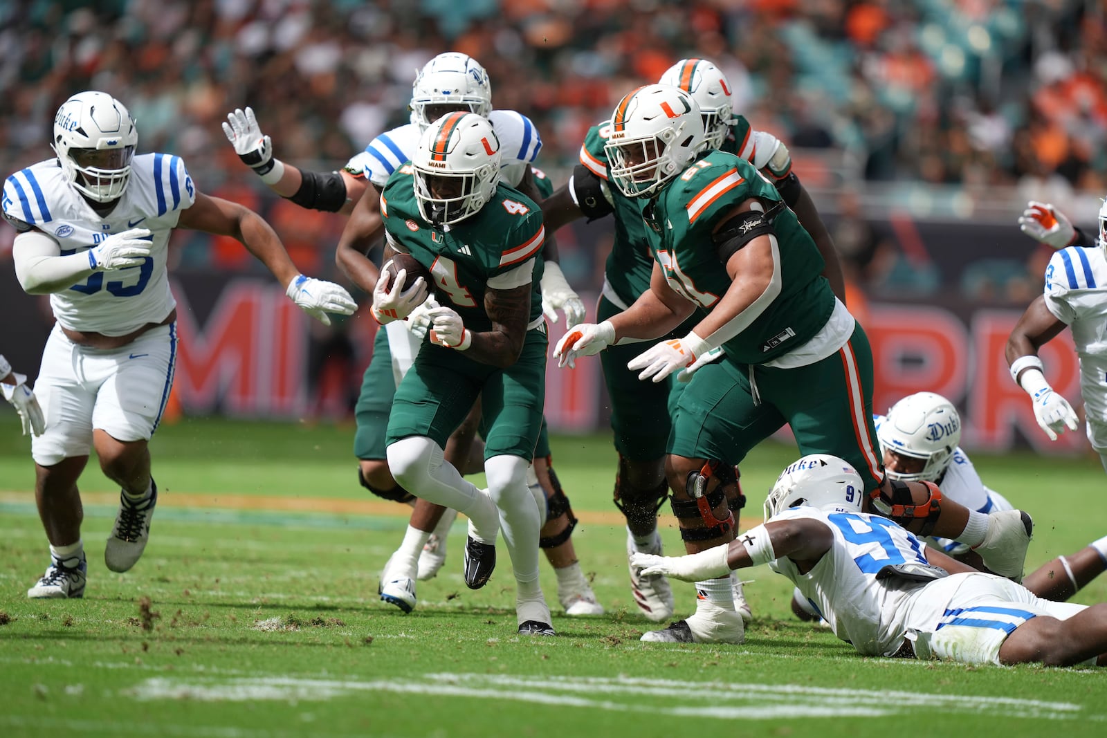 Miami running back Mark Fletcher Jr. (4) runs for a first down during the first half of an NCAA college football game against Duke, Saturday, Nov. 2, 2024, in Miami Gardens, Fla. (AP Photo/Lynne Sladky)