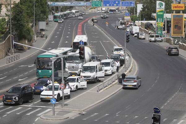 People stand still by their cars to observe two minutes of silence as air raid sirens sound marking the Israel's annual Memorial Day for the fallen soldiers and victims of nationalistic attacks in Jerusalem, Wednesday, April 30, 2025. (AP Photo/Mahmoud Illean)