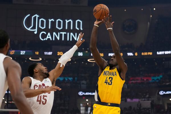 Indiana Pacers forward Pascal Siakam (43) shoots over Cleveland Cavaliers' Donovan Mitchell (45) in the first half during Game 1 in the Eastern Conference semifinals of the NBA basketball playoffs Sunday, May 4, 2025, in Cleveland. (AP Photo/Sue Ogrocki)