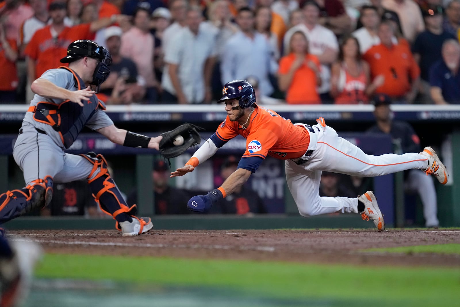 Detroit Tigers catcher Jake Rogers reaches out for the throw to the plate as Houston Astros' Jeremy Pena, right, scores on a Jose Altuve sacrifice fly in the seventh inning of Game 2 of an AL Wild Card Series baseball game Wednesday, Oct. 2, 2024, in Houston. (AP Photo/Kevin M. Cox)