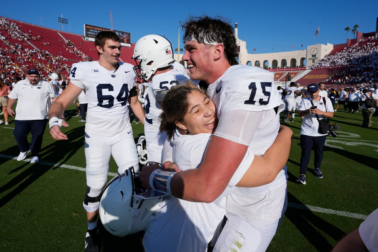 Penn State quarterback Drew Allar (15) is hugged after an overtime win over Southern California during an NCAA college football game Saturday, Oct. 12, 2024, in Los Angeles. (AP Photo/Marcio Jose Sanchez)