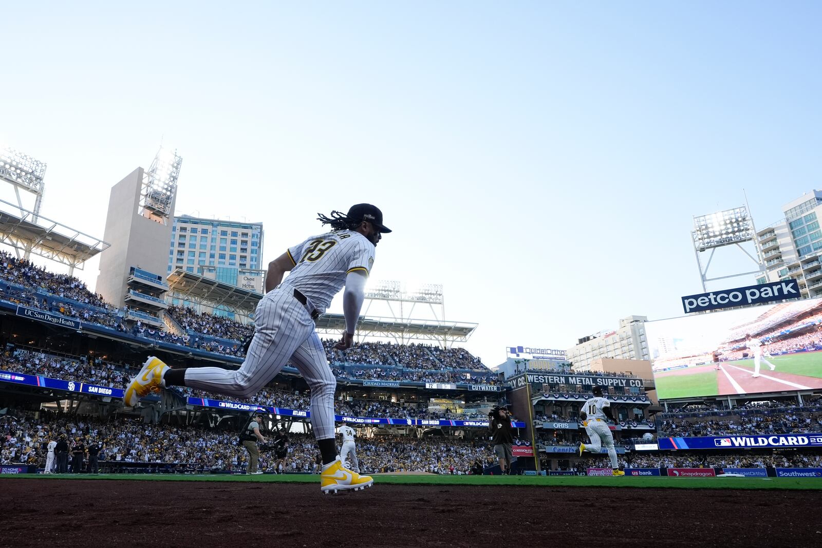 San Diego Padres' Fernando Tatis Jr. runs onto the field at the start of Game 1 of an NL Wild Card Series baseball game against the Atlanta Braves, Tuesday, Oct. 1, 2024, in San Diego. (AP Photo/Gregory Bull)