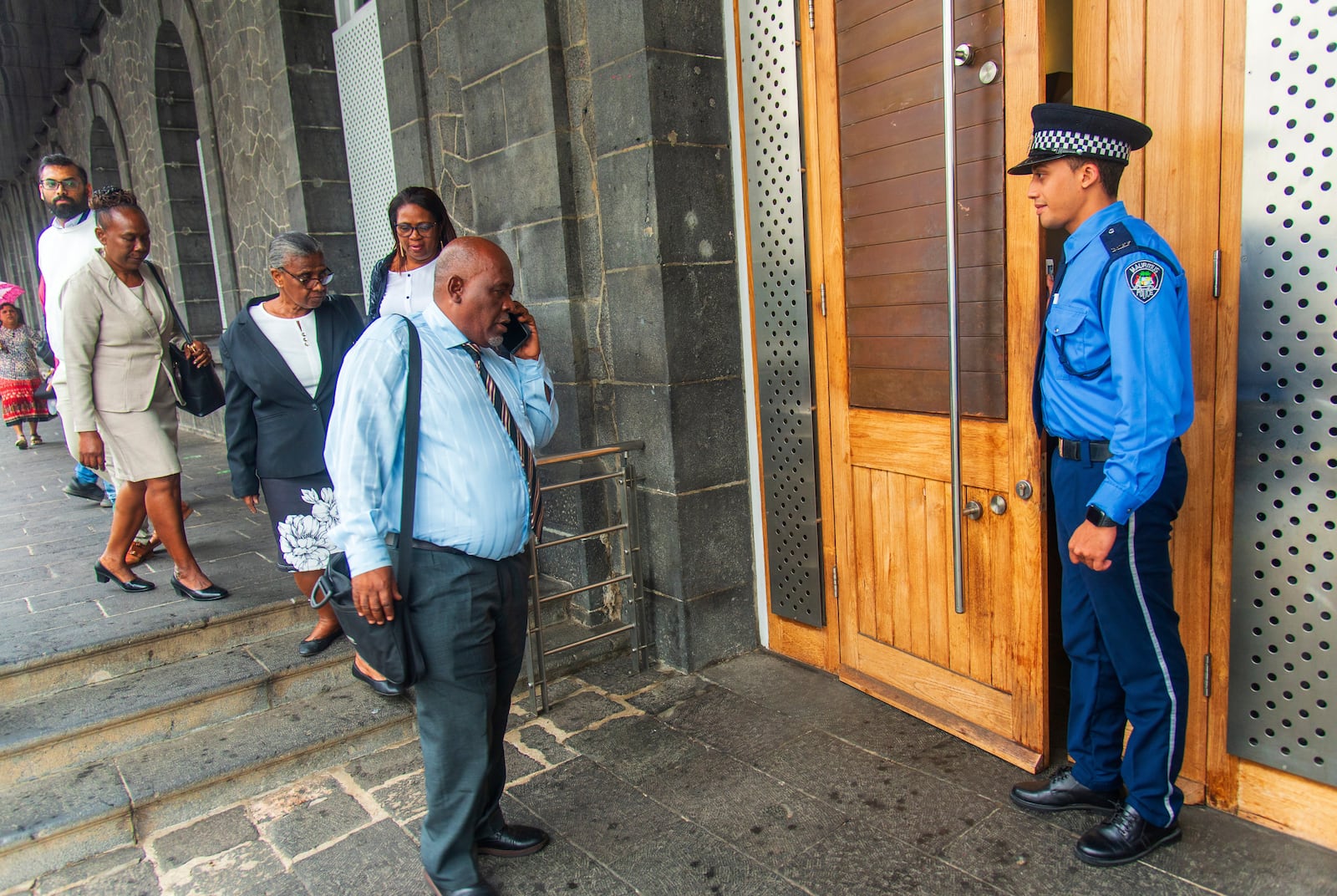 Chagossians, led by Olivier Bancoult, on phone at center, outside the Mauritian Prime Minister's office in Port Louis, Mauritius, Thursday, Oct. 3, 2024, after the news that the U.K. had agreed to hand sovereignty of the long-contested Chagos Islands to Mauritius. (Sokrah Kiranchand/l'Express Mauritius via AP)