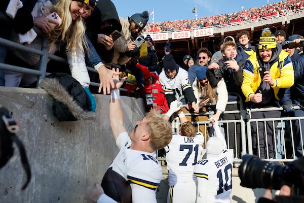 Michigan players celebrate their win over Ohio State in an NCAA college football game Saturday, Nov. 30, 2024, in Columbus, Ohio. (AP Photo/Jay LaPrete)