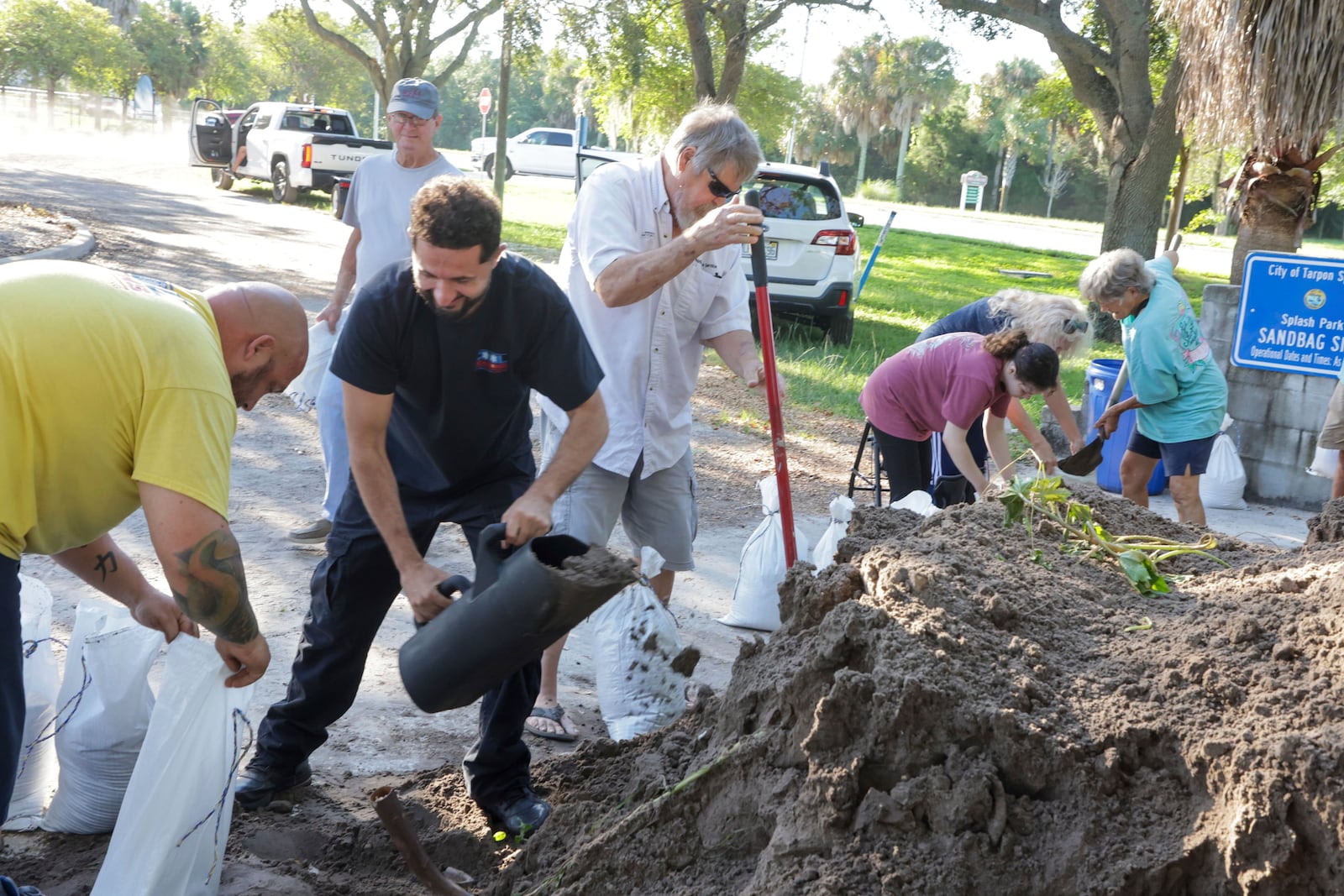 Sandbags are filled at a public site while residents prepare their homes for potential flooding, Tuesday, Sep 24, 2024, in Tarpon Springs, Fla., as Tropical Storm Helene approaches. (Douglas R. Clifford/Tampa Bay Times via AP)