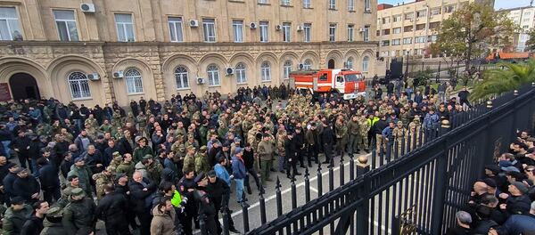 In this photo taken from video released by AIASHARA Independent Agency, Protesters gather outside the parliament building of the Georgian separatist region of Abkhazia as tensions flared over a proposed pact that would allow Russians to buy apartments in the region, Georgia, on Friday, Nov. 15, 2024, (AIASHARA Independent Agency via AP)