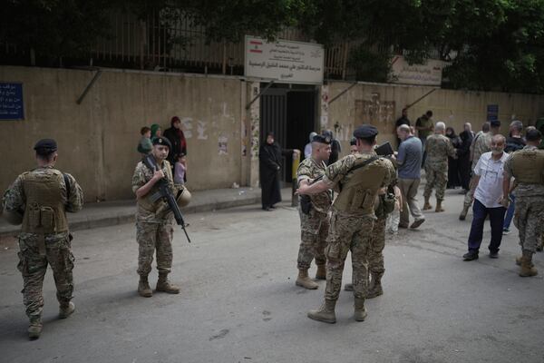 Lebanese army soldiers secure the area as voters arrive at a polling station during municipal elections in the southern suburbs of Beirut, Lebanon, Sunday, May 4, 2025. (AP Photo/Hassan Ammar)