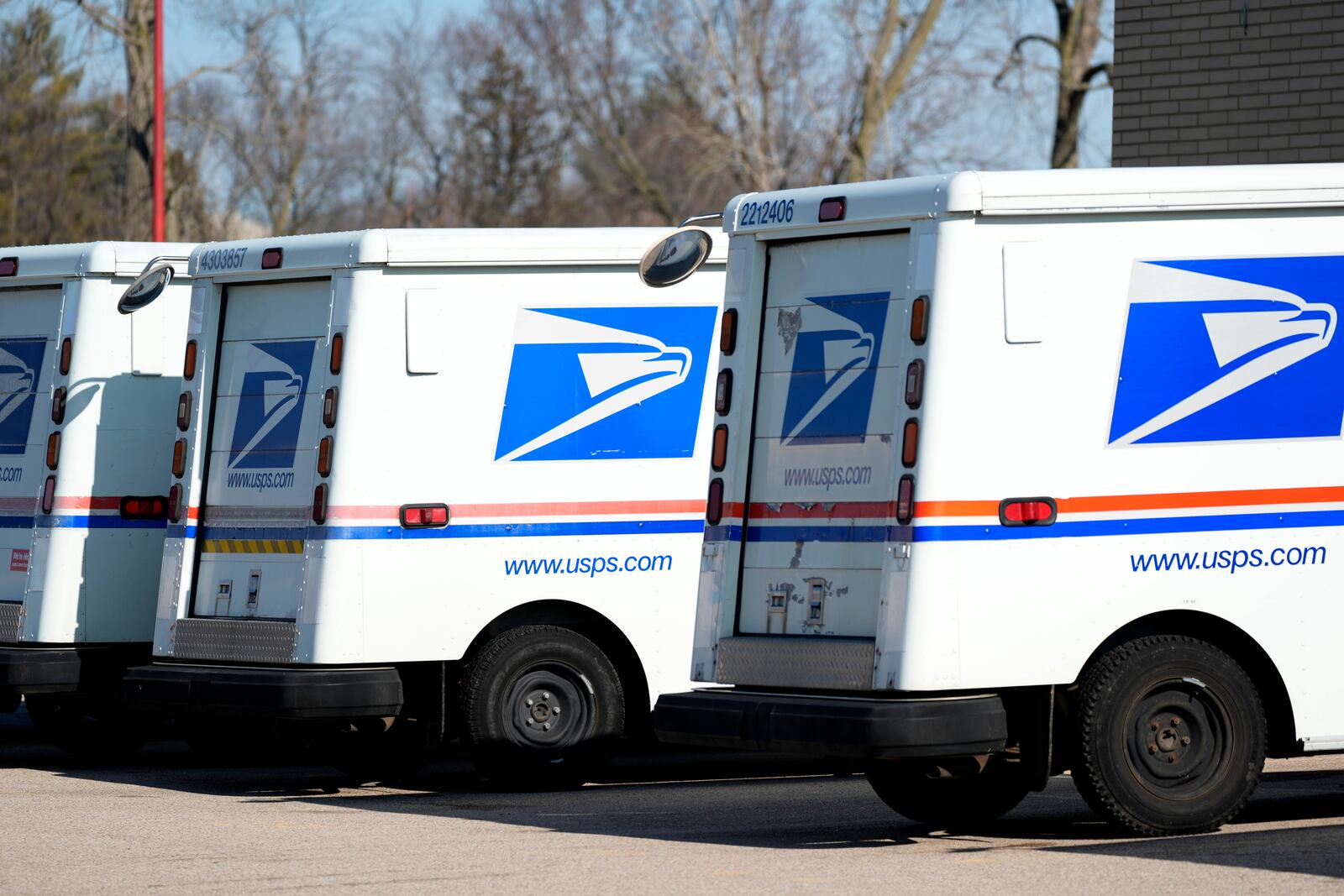 FILE - U.S. Postal Service trucks park outside a post office in Wheeling, Ill., Monday, Jan. 29, 2024. (AP Photo/Nam Y. Huh, File)