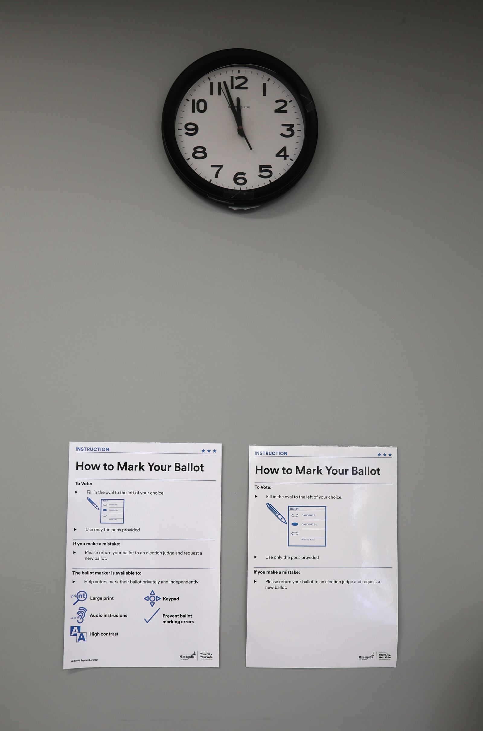 Instructions are posted on the wall inside the City of Minneapolis early voting center, Thursday, Sept. 19, 2024, in St. Paul, Minn. In-person voting in the 2024 presidential contest begins Friday in three states, including Democratic vice presidential candidate Tim Walz's home state of Minnesota, with just over six weeks left before Election Day. (AP Photo/Adam Bettcher)