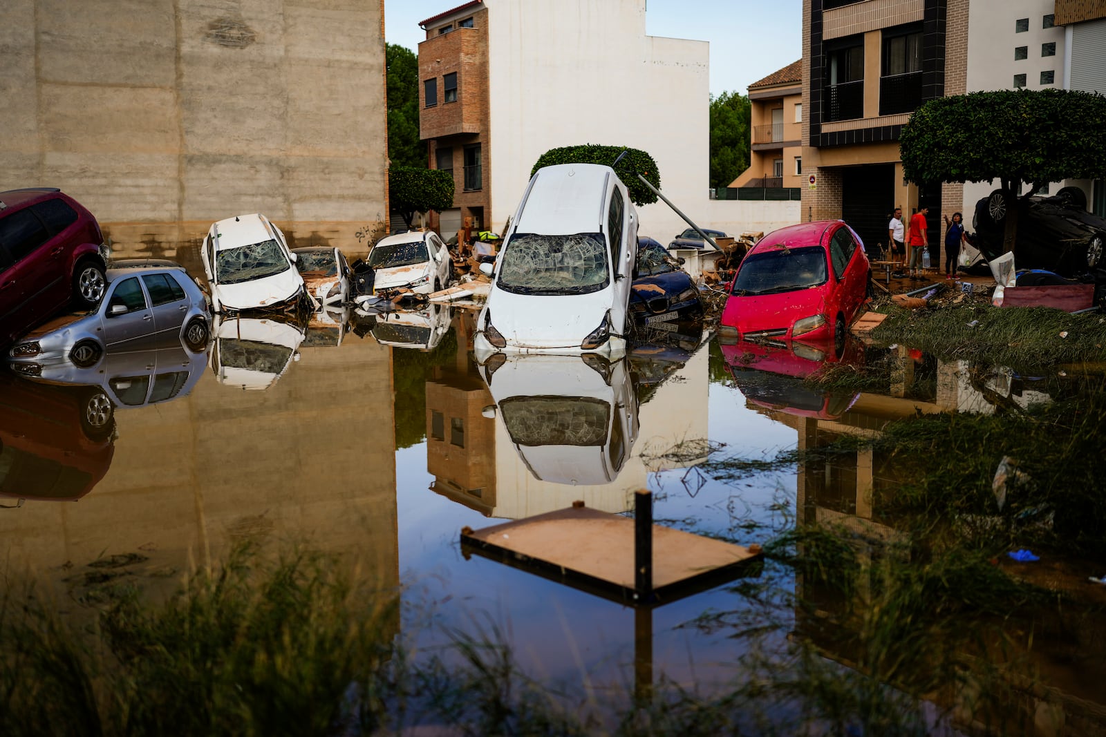 Flooded cars piled up are pictured in Valencia, Spain, Thursday, Oct. 31, 2024. (AP Photo/Manu Fernandez)