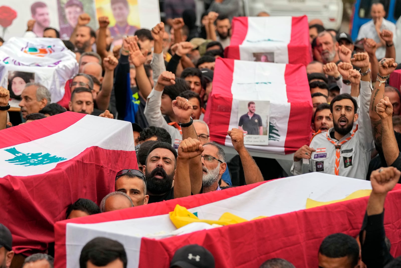 Mourners carry the coffins of their relatives, killed on Saturday in an Israeli airstrike, during their funeral procession in Maisara near the northern coastal town of Byblos, Lebanon, Monday, Oct. 14, 2024. (AP Photo/Hassan Ammar)