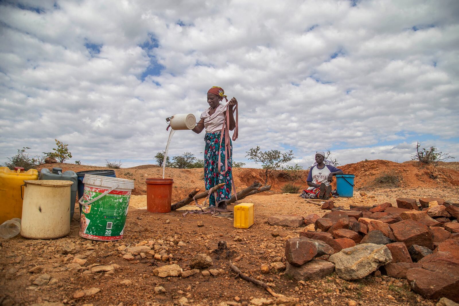 File — Villagers fetch water from a makeshift borehole in Mudzi, Zimbabwe, Tuesday, July 2, 2024. as the United Nations' food agency says months of drought in southern Africa, triggered by the El Nino weather phenomenon, has had a devastating impact on more than 27 million people and caused the region's worst hunger crisis in decades. (AP Photo/Aaron Ufumeli/File)