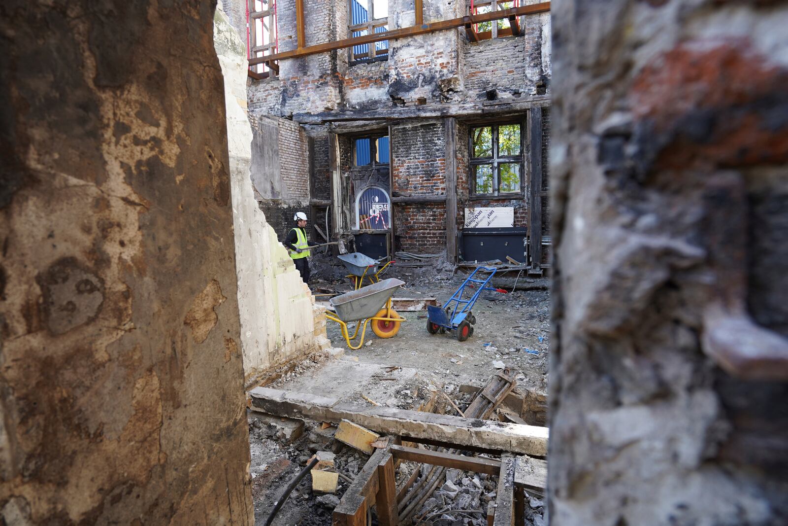 Workers clear rubble at Copenhagen's Old Stock Exchange building in Copenhagen, Denmark, Thursday, Sept. 19, 2024. (AP Photo James Brooks)