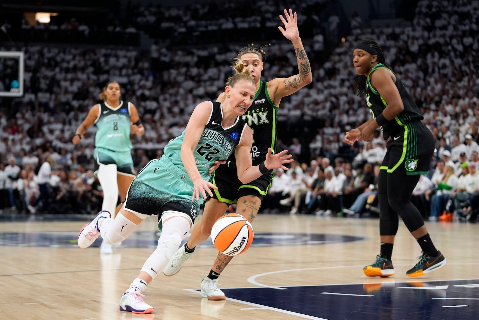 New York Liberty guard Courtney Vandersloot (22) drives to the basket past Minnesota Lynx guard Natisha Hiedeman during the first half in Game 3 of a WNBA basketball final playoff series, Wednesday, Oct. 16, 2024, in Minneapolis. (AP Photo/Abbie Parr)