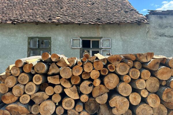Firewood is stacked outside a house in the village of Saschiz, in Romania's central Transylvania region, Friday, April 25, 2025. (AP Photo/Stephen McGrath)