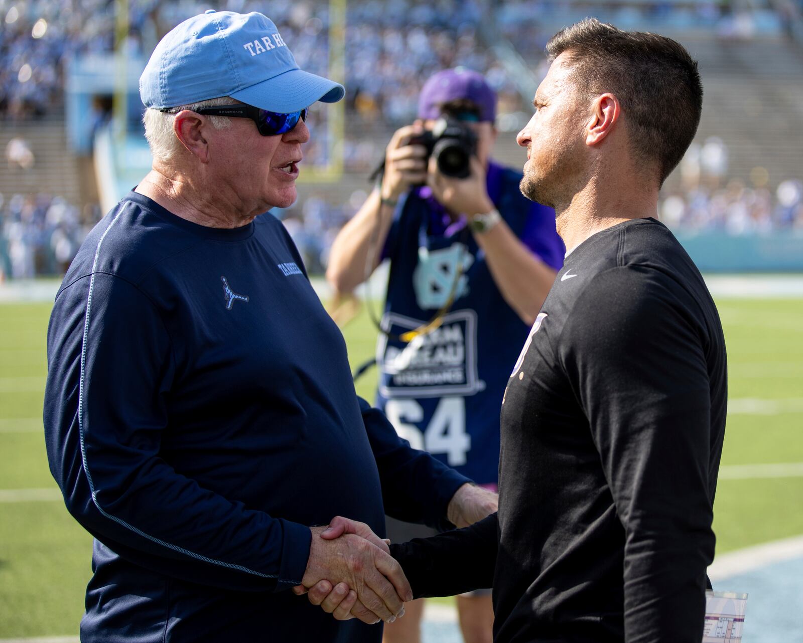 North Carolina head coach Mack Brown shakes hands with James Madison head coach Bob Chesney at the end of an NCAA college football game in Chapel Hill, N.C., Saturday, Sept. 21, 2024. (Daniel Lin/Daily News-Record via AP)