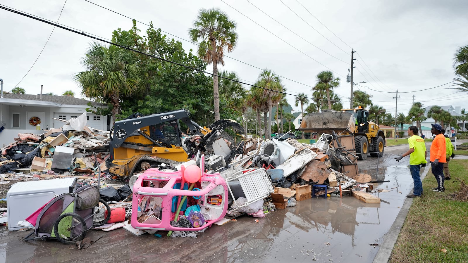 Salvage works remove debris from Hurricane Helene flooding along the Gulf of Mexico before approaching Milton, Monday, Oct. 7, 2024, in Clearwater Beach, Fla. (AP Photo/Chris O'Meara)