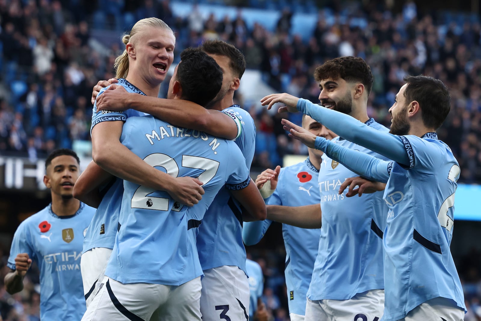 Manchester City's Erling Haaland celebrates with teammates after scoring his side's opening goal during the English Premier League soccer match between Manchester City and Southampton at the Etihad Stadium in Manchester, England, Saturday, Oct. 26, 2024. (AP Photo/Darren Staples)