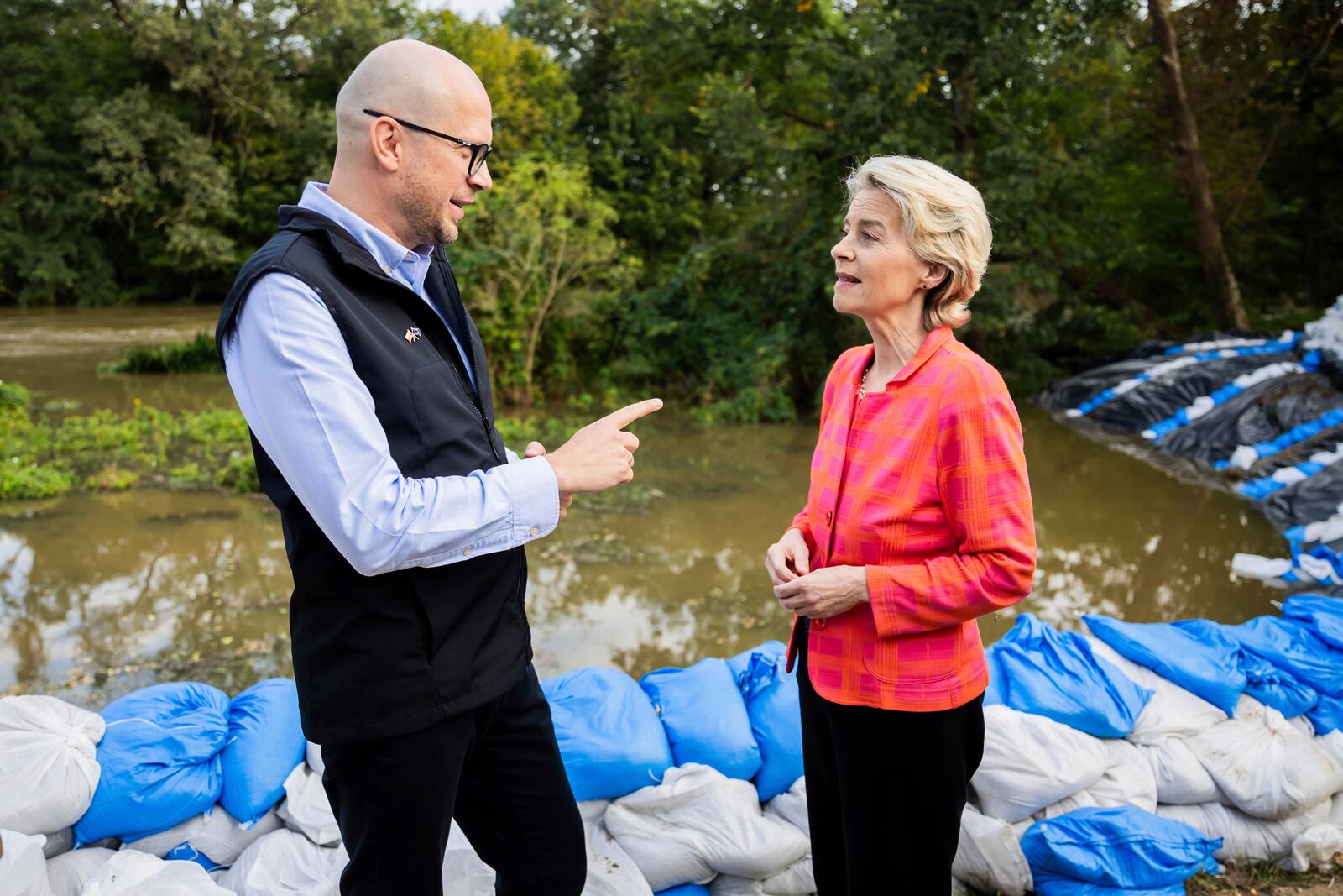 European Commmission President Ursula von der Leyen, right, talks to Jakub Mazur, First Deputy Mayor of Wroclaw, next to the river Bystrzyca near Woclaw, Poland, Thursday, Sept. 19, 2024. (Christoph Soeder/DPA via AP, Pool)