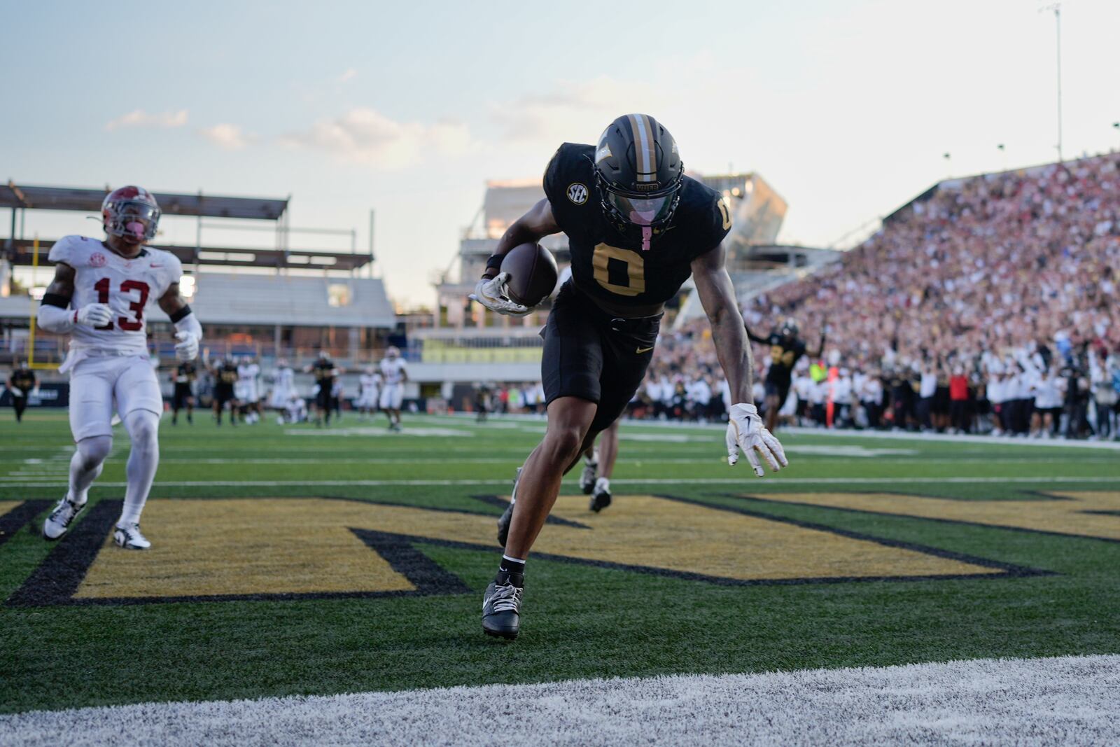 Vanderbilt wide receiver Junior Sherrill (0) makes a catch for a touchdown past Alabama defensive back Malachi Moore (13) during the second half of an NCAA college football game Saturday, Oct. 5, 2024, in Nashville, Tenn. (AP Photo/George Walker IV)