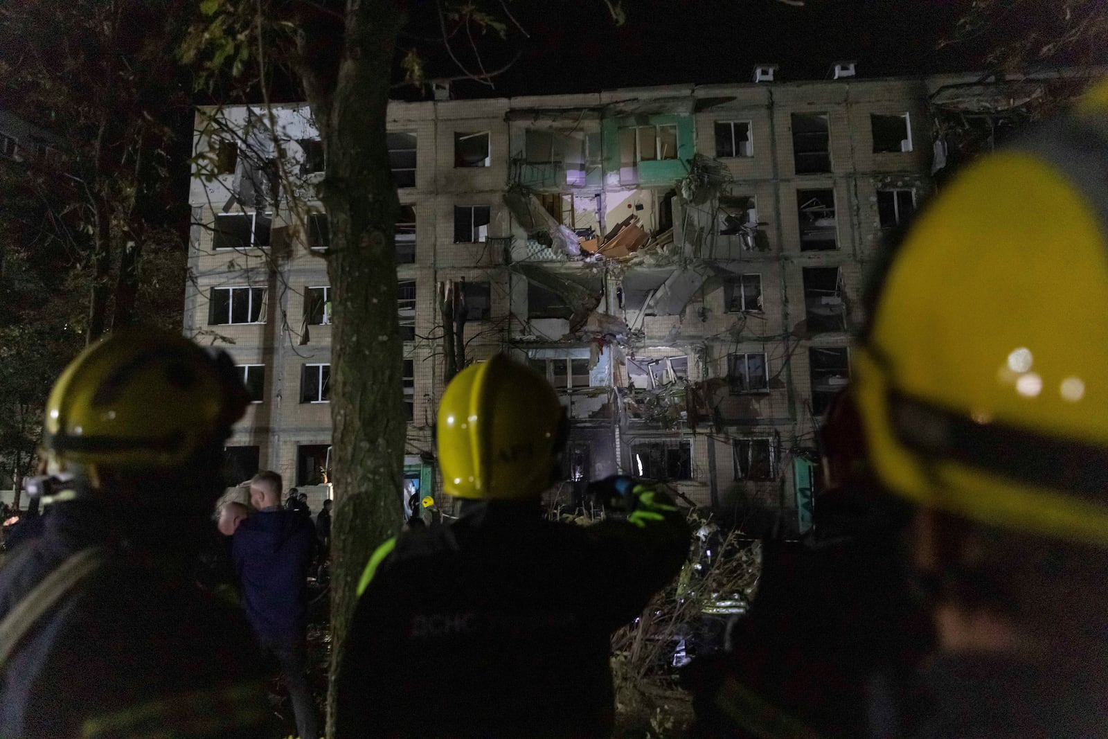 FILE - Firefighters work on a site of a building damaged by a Russian airstrike in Kharkiv, Ukraine, on Oct. 3, 2024. (AP Photo/Yevhen Titov, File)