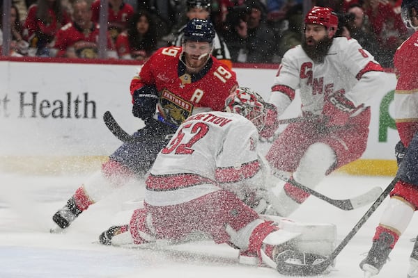 Carolina Hurricanes goaltender Pyotr Kochetkov (52) defends the goal against Florida Panthers left wing Matthew Tkachuk (19) during the second period in Game 3 of the NHL hockey Stanley Cup Eastern Conference finals Saturday, May 24, 2025, in Sunrise, Fla. (AP Photo/Lynne Sladky)