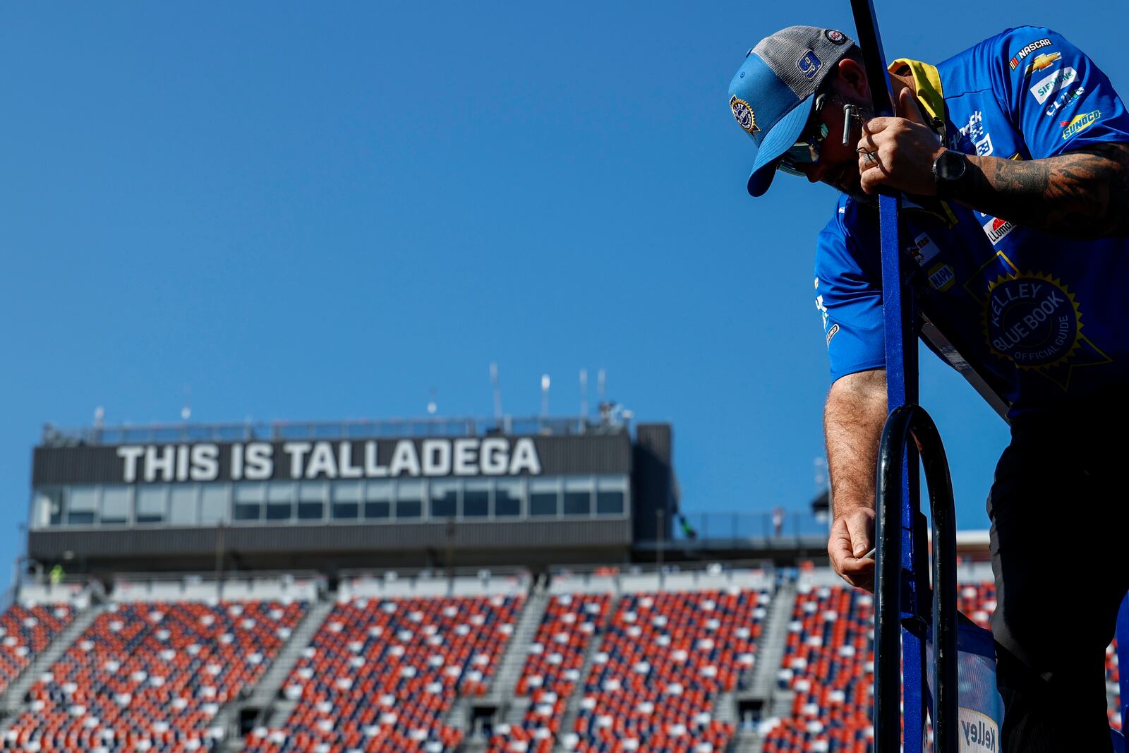 A crew member of driver Chase Elliott (9) preps the Pit Stall before a NASCAR Cup Series auto race at Talladega Suoperspeedway, Sunday, Oct. 6, 2024, in Talladega, Ala. (AP Photo/ Butch Dill)