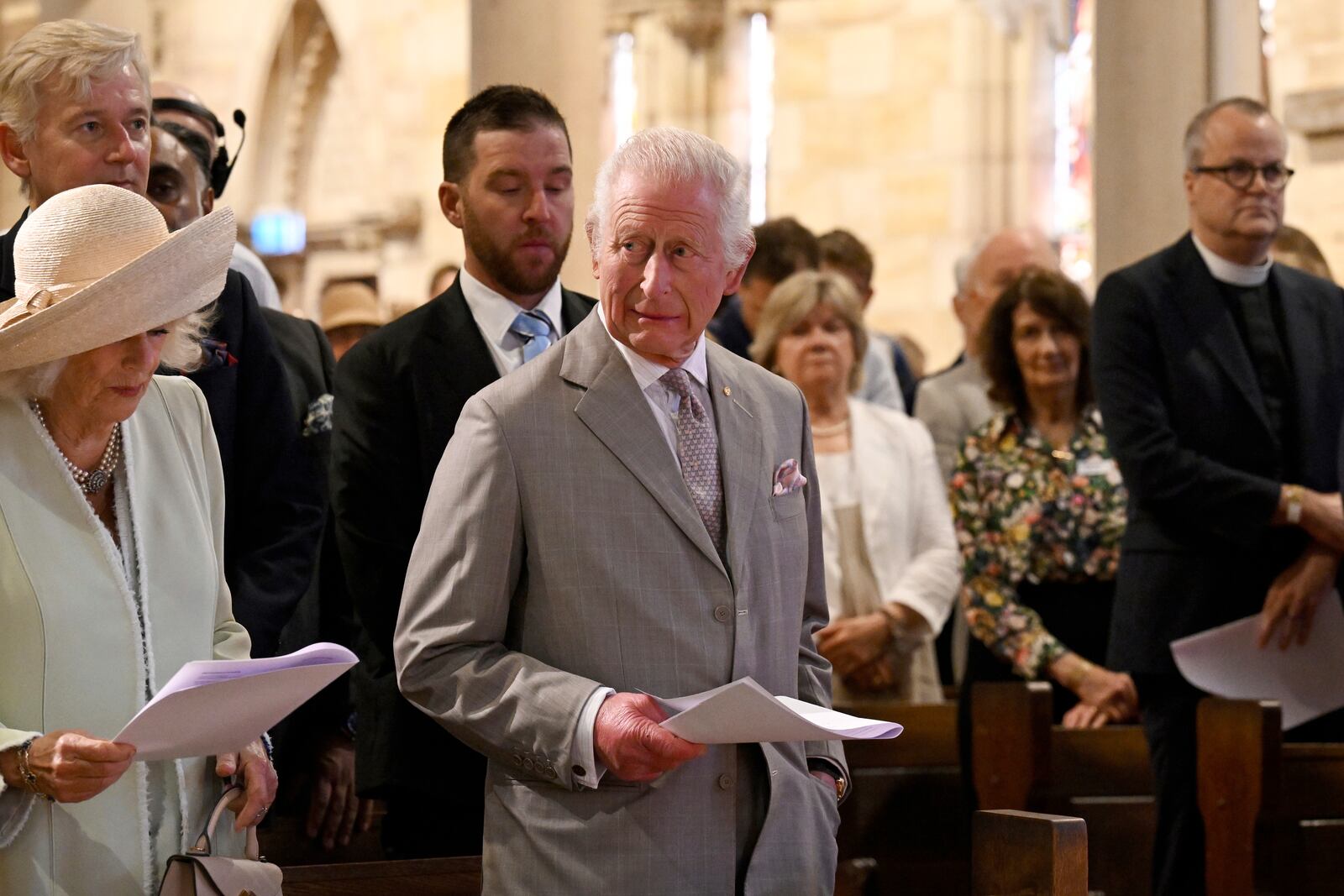 King Charles III, center, and Queen Camilla, left, stand during a visit to St Thomas' Anglican Church in Sydney, Sunday, Oct. 20, 2024. (Dean Lewins/Pool Photo via AP)