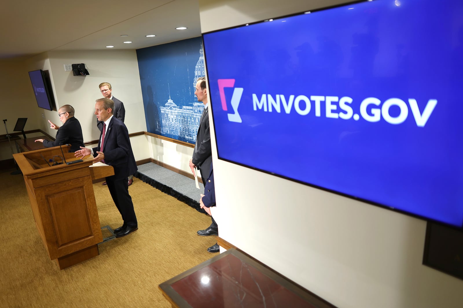 Minnesota Secretary of State Steve Simon speaks to the media with some of his election staff about early voting at the Minnesota State Capitol, Thursday, September 19, 2024, in St. Paul, Minn. (AP Photo/Adam Bettcher)