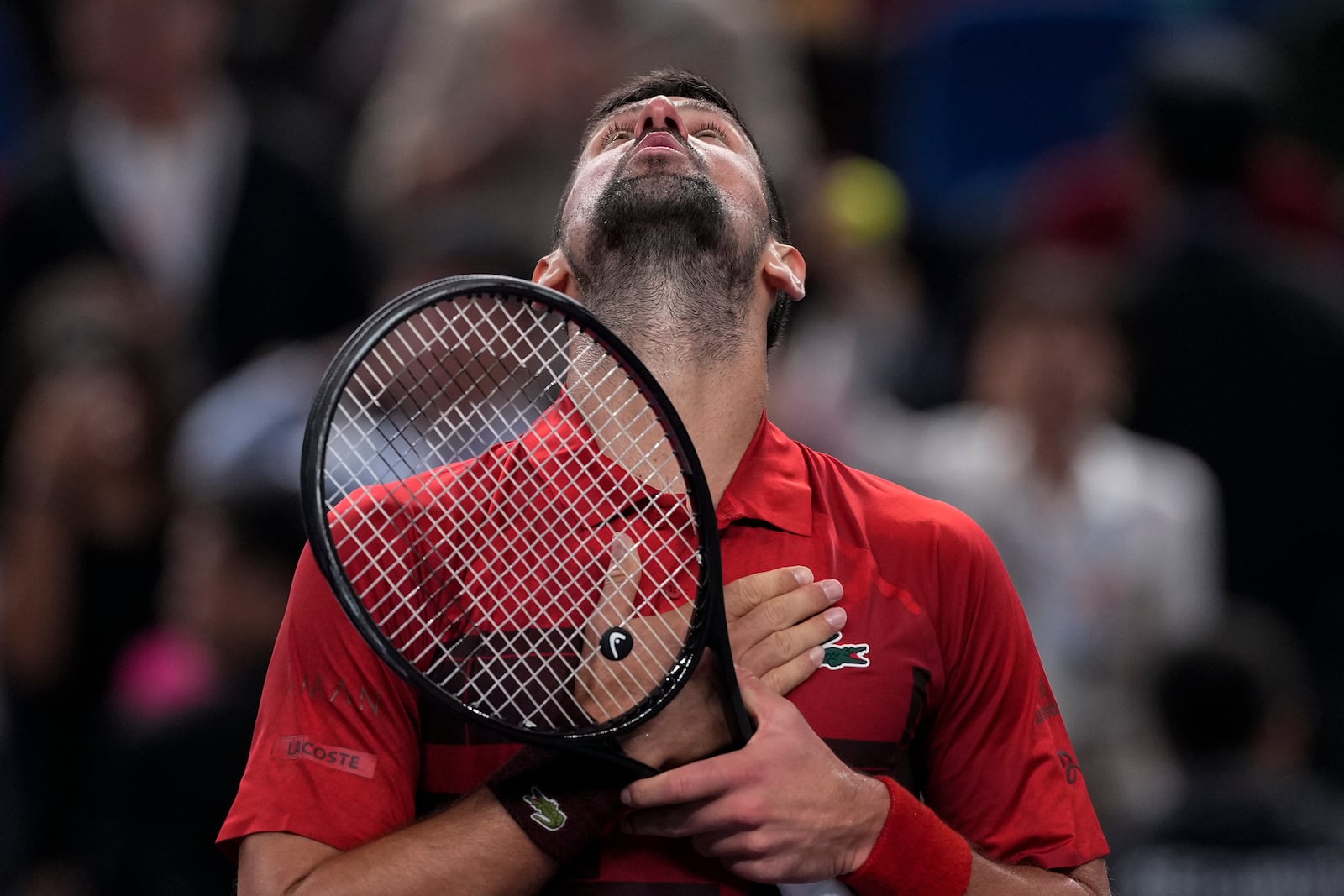 Novak Djokovic of Serbia reacts after defeating Taylor Fritz of the United States in the men's singles semifinals match of the Shanghai Masters tennis tournament at Qizhong Forest Sports City Tennis Center in Shanghai, China, Saturday, Oct. 12, 2024. (AP Photo/Andy Wong)