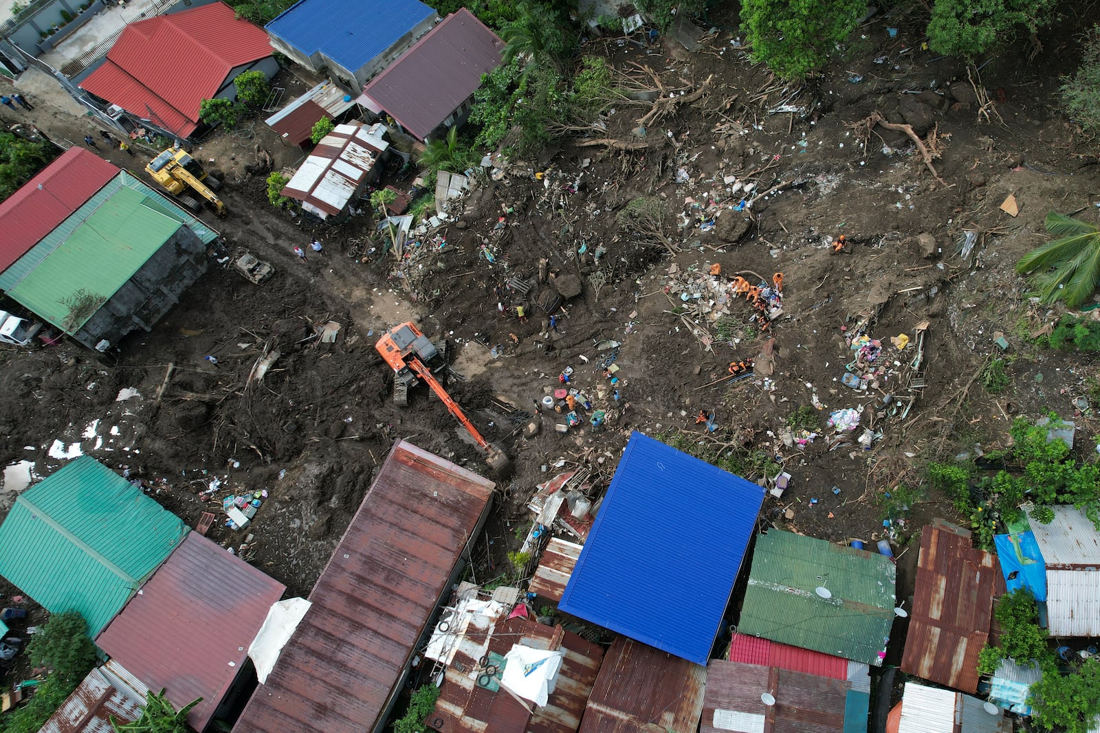 Rescuers work at the site after a recent landslide triggered by Tropical Storm Trami struck Talisay, Batangas province, Philippines leaving thousands homeless and several villagers dead on Saturday, Oct. 26, 2024. (AP Photo/Aaron Favila)