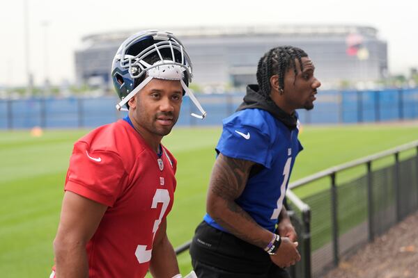 New York Giants' quarterback Russell Wilson, left, and Malik Nabers talk as they walk off the field after an NFL football practice in East Rutherford, N.J., Wednesday, May 28, 2025. (AP Photo/Seth Wenig)