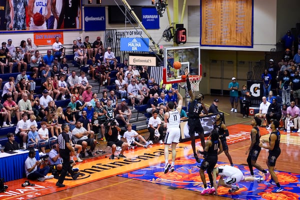 UConn forward Alex Karaban (11) shoots against Memphis center Moussa Cisse (32) during the first half of an NCAA college basketball game at the Maui Invitational Monday, Nov. 25, 2024, in Lahaina, Hawaii. (AP Photo/Lindsey Wasson)