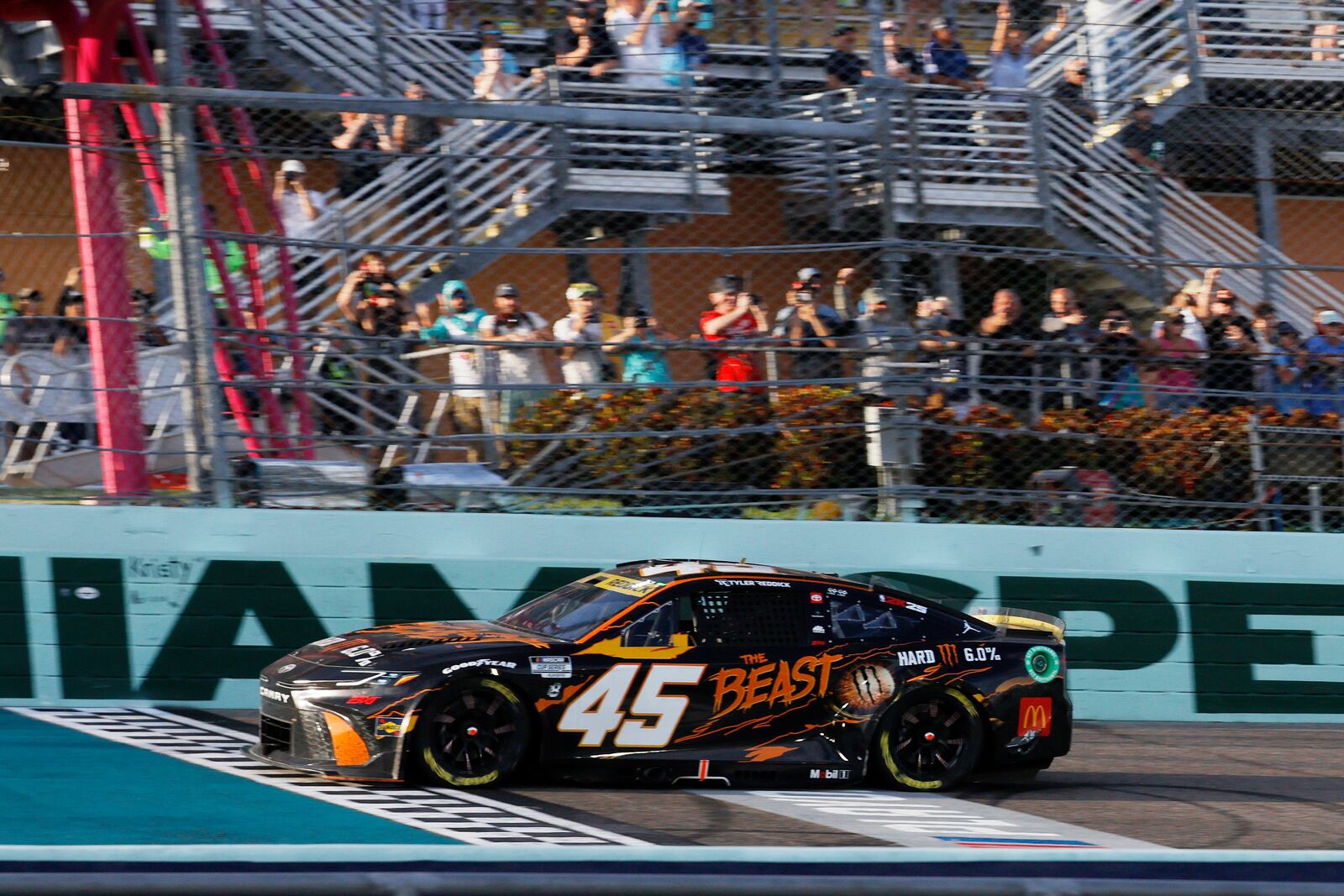 Tyler Reddick crosses the finish line to win a NASCAR Cup Series auto race at Homestead-Miami Speedway in Homestead, Fla., Sunday, Oct. 27, 2024. (AP Photo/Terry Renna)