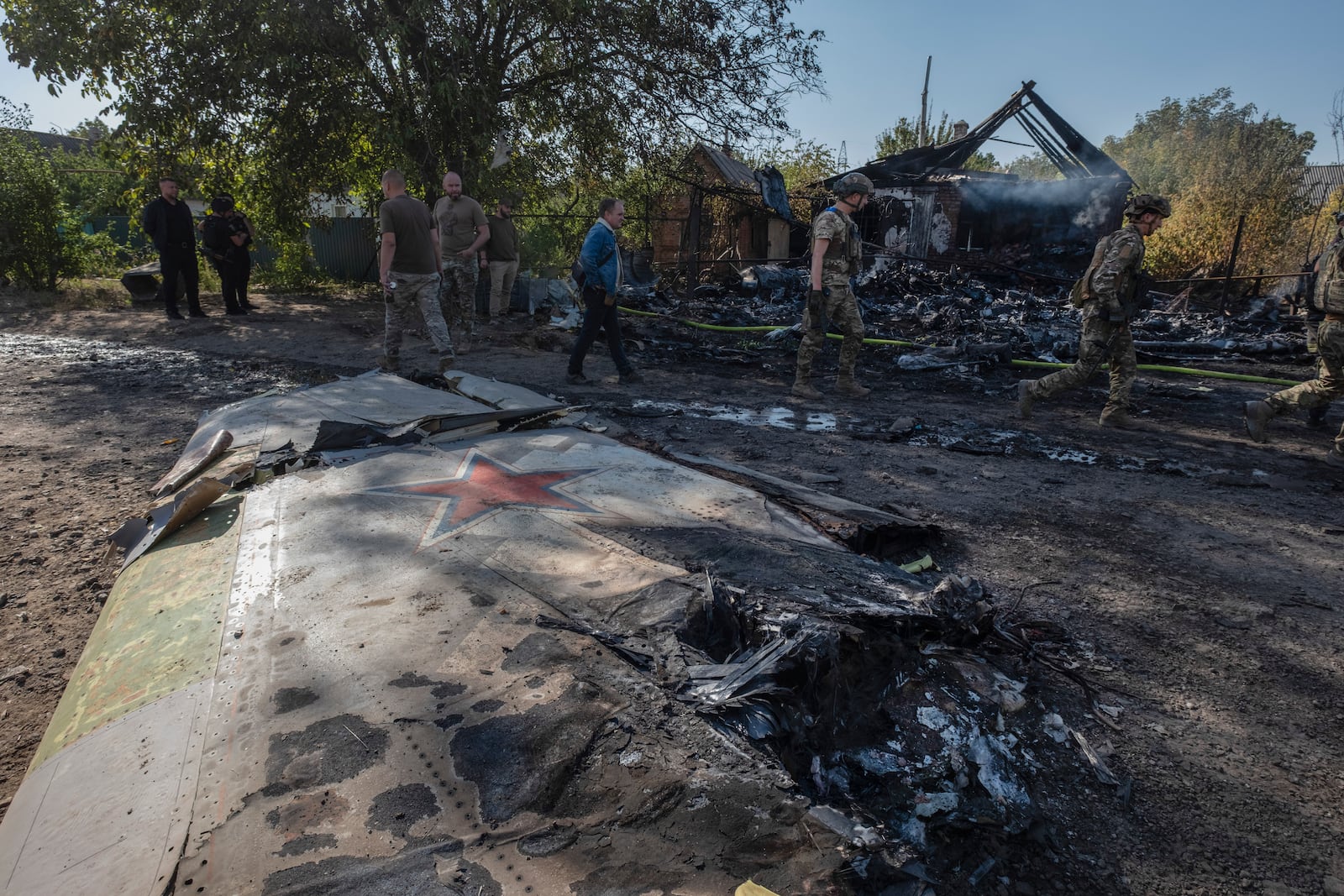 Ukrainian servicemen examine fragments of a Russian military plane that was shot down, on the outskirts of Kostyantynivka, a near-front line city in the Donetsk region, Ukraine, Saturday, Oct. 5, 2024. (Iryna Rybakova via AP)