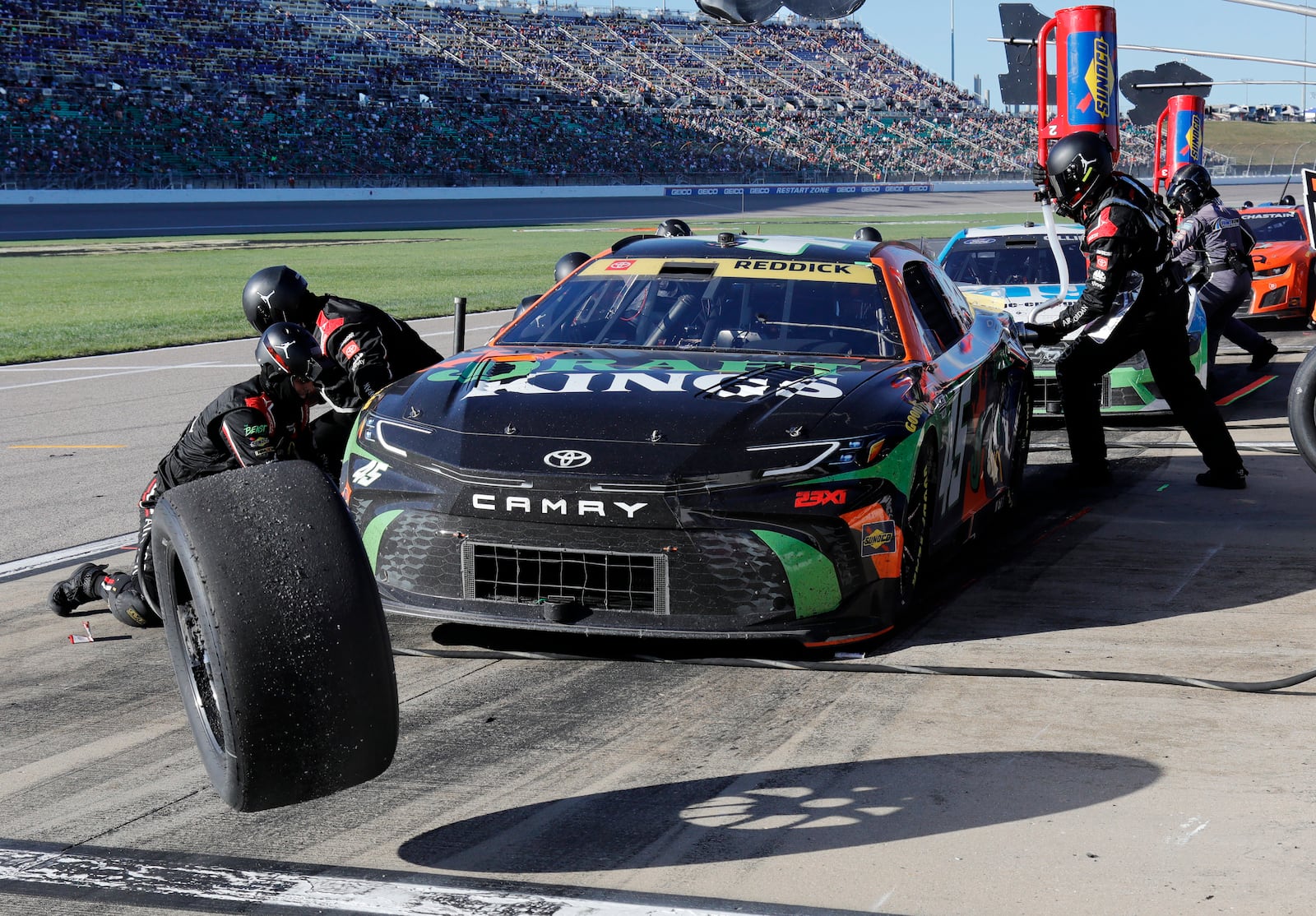 Tyler Reddick (45) has his tires changed on pit road during a NASCAR Cup Series auto race at Kansas Speedway in Kansas City, Kan., Sunday, Sept. 29, 2024. (AP Photo/Colin E. Braley)