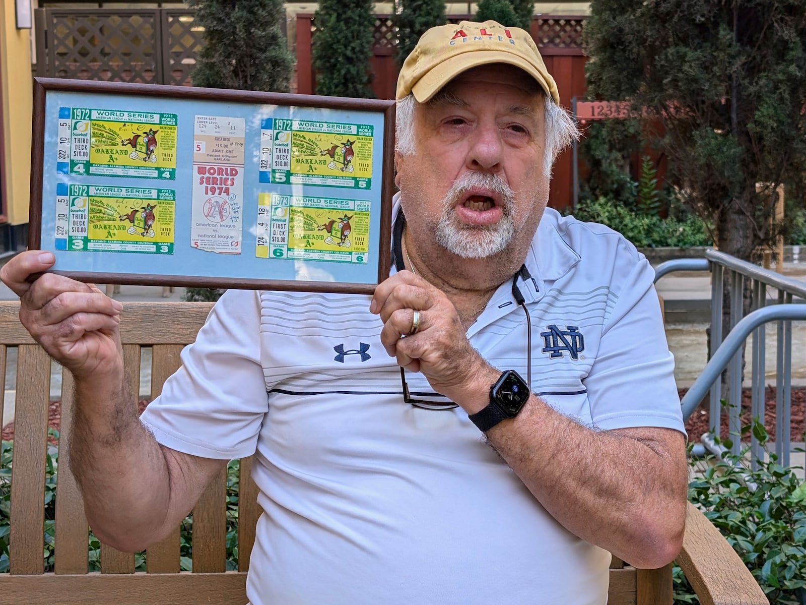 Longtime Oakalnd A's fan Mike Silva holds up his framed ticket stubs from the team's World Series games at the Oakland Coliseum, July 16, 2024, in San Jose, Calif., from 1972-74, resulting in three of the nine World Series titles dating back to the franhise's orgins in Philadelphia. (AP Photo/Michael Liedtke)