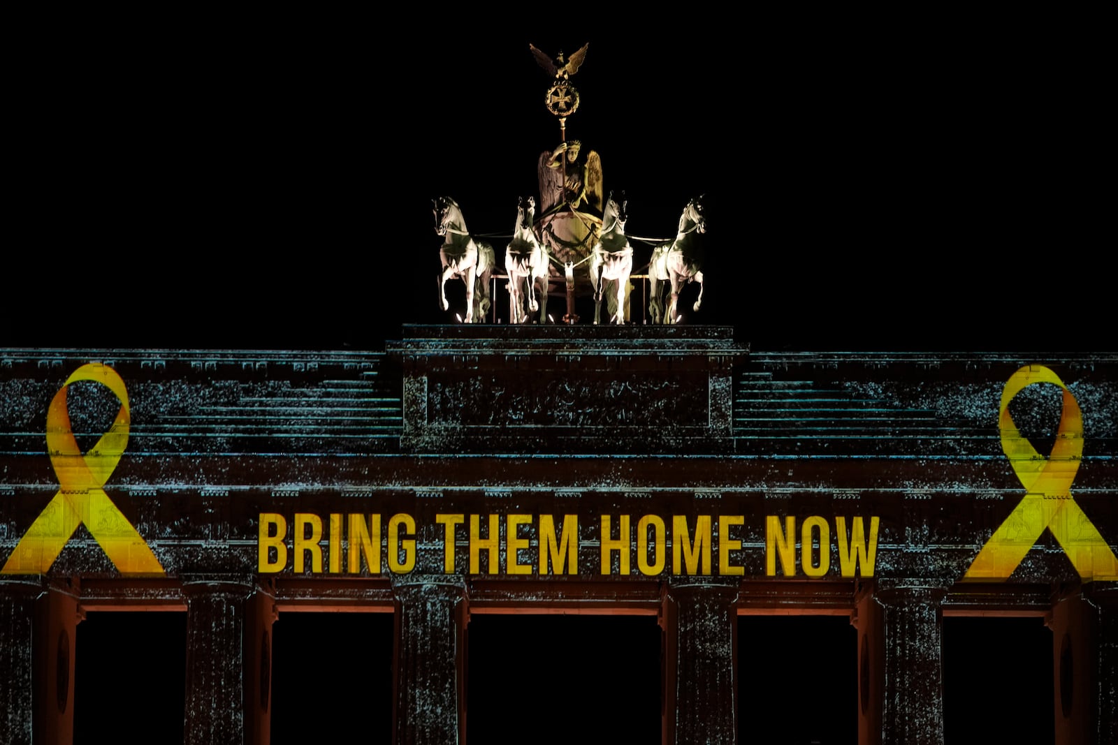 The Brandenburg Gate is illuminated in solidarity with Israel, marking the first anniversary of the Hamas spearheaded attacks on Israel, in Berlin, Germany, Monday, Oct. 7, 2024. (AP Photo/Markus Schreiber)