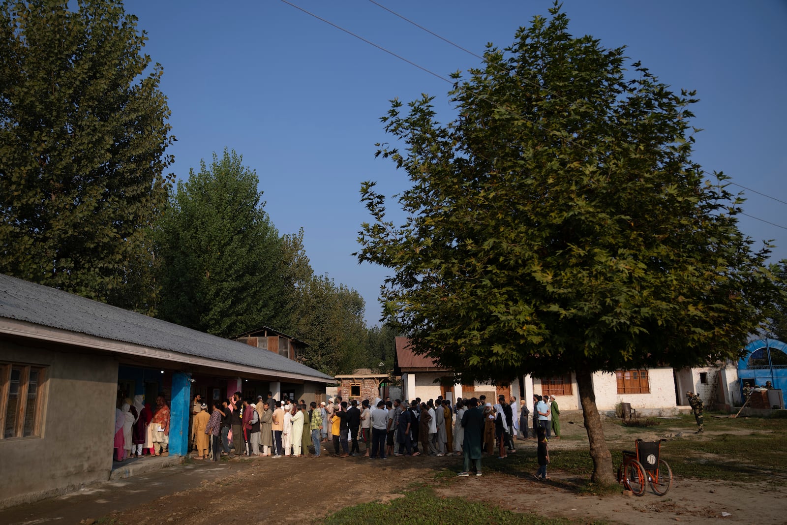 Kashmiri's queue up at a polling booth to cast their vote during the second phase of the assembly election in the outskirts of Srinagar, Indian controlled Kashmir, Wednesday, Sept. 25, 2024. (AP Photo/Dar Yasin)