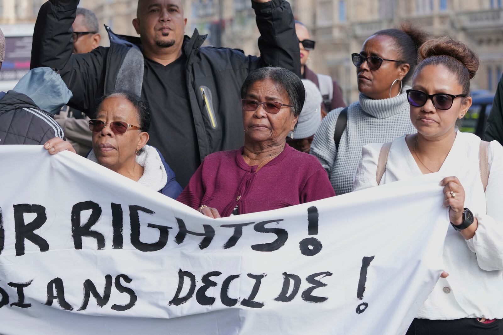 Chagossians Lucy Sagai, center, attends a protest to response the U.K. announcement to agree to hand sovereignty of the long-contested Chagos Islands to Mauritius and against their "Exclusion" from Chagos negotiations, outside the House of Parliament, in London, Monday, Oct. 7, 2024. (AP Photo/Kin Cheung)