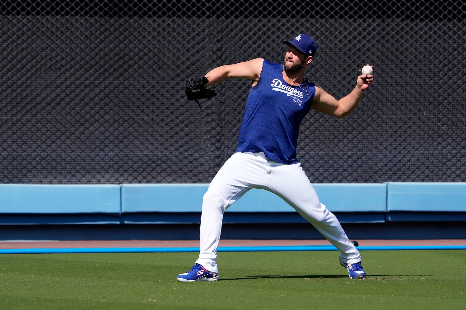 Los Angeles Dodgers pitcher Clayton Kershaw warms up during practice in preparation for Game 1 of a baseball NL Division Series against the San Diego Padres, Thursday, Oct. 3, 2024, in Los Angeles. (AP Photo/Mark J. Terrill)