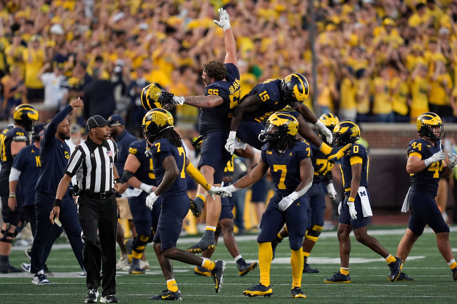 Michigan players celebrate a stop on fourth down against the Southern California in the second half of an NCAA college football game in Ann Arbor, Mich., Saturday, Sept. 21, 2024. (AP Photo/Paul Sancya)