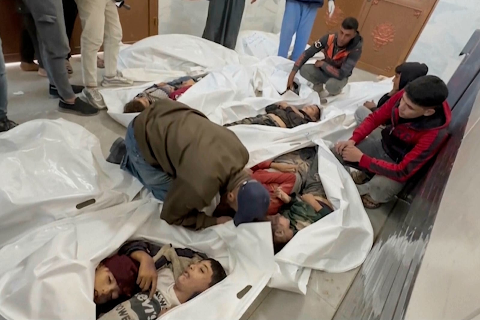 EDS NOTE: GRAPHIC CONTENT - A Palestinian kisses a relative killed in Israeli airstrikes, in a morgue in the city of Khan Younis, southern Gaza Strip, Friday, Oct. 25, 2024. (AP Photo)