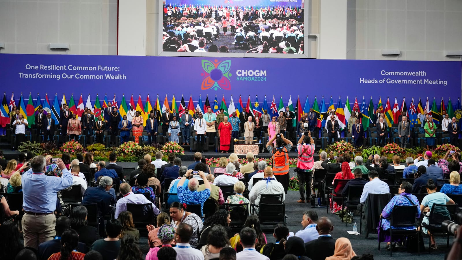 Britain's King Charles stands with the delegates for a family photo during the opening ceremony for the Commonwealth Heads of Government meeting in Apia, Samoa, Friday, Oct. 25, 2024. (AP Photo/Rick Rycroft/Pool)