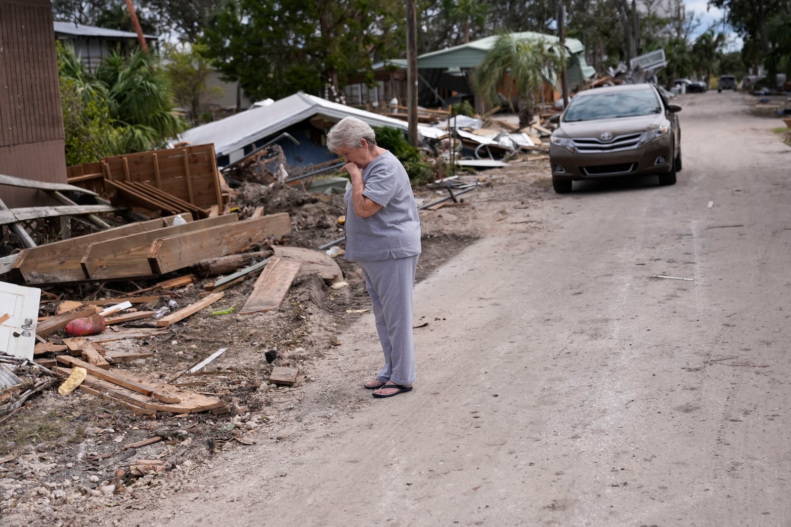 Elsie Hicks looks at the destruction of the home she has loved in for 25 years, in the aftermath of Hurricane Helene, in Horseshoe Beach, Fla., Saturday, Sept. 28, 2024. (AP Photo/Gerald Herbert)