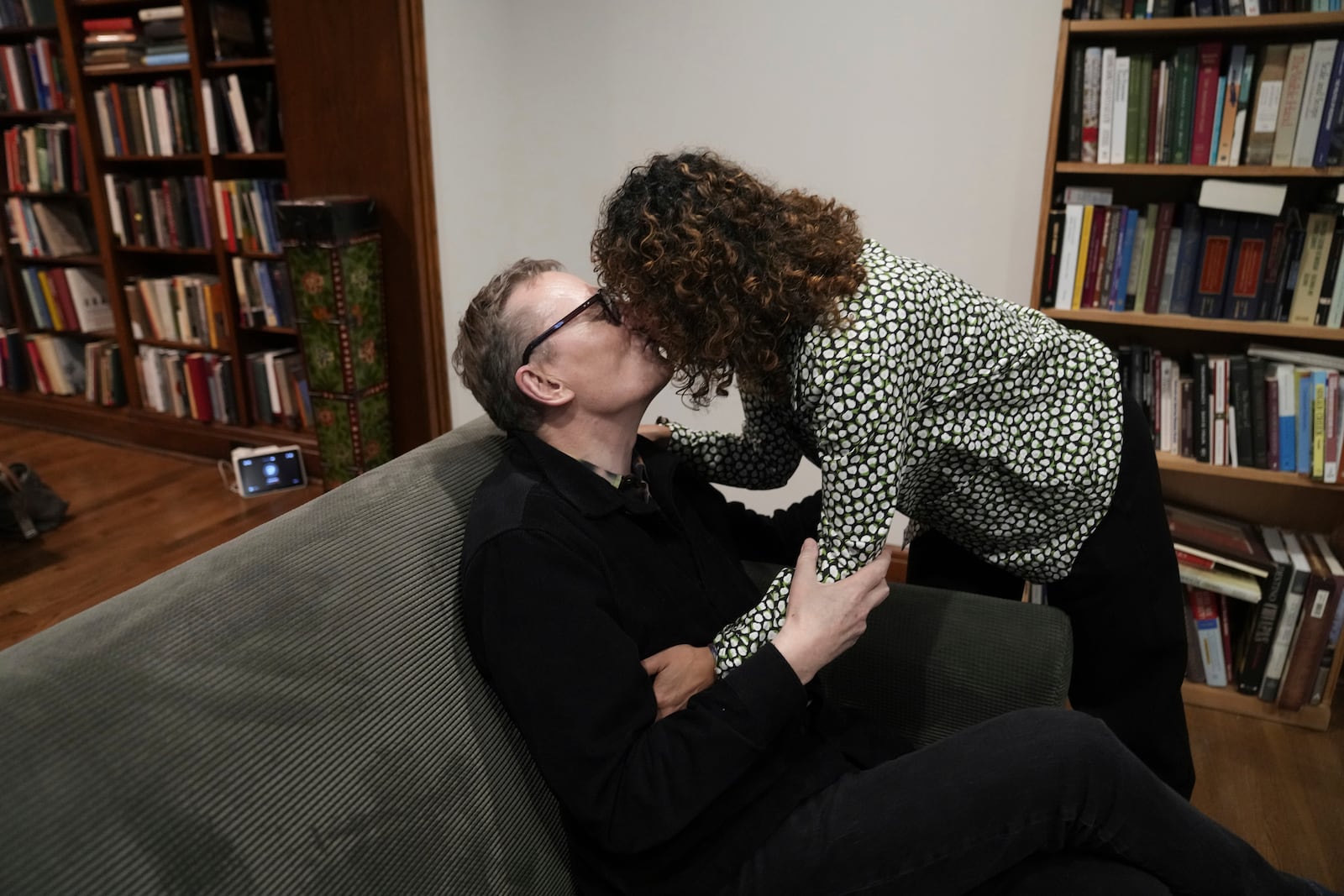 Nobel prize winner in Economics, James A. Robinson, kisses his wife, Dr. Maria Angelica Bautista, at his home in the Hyde Park neighborhood of Chicago, Monday, Oct. 14, 2024. (AP Photo/Charles Rex Arbogast)