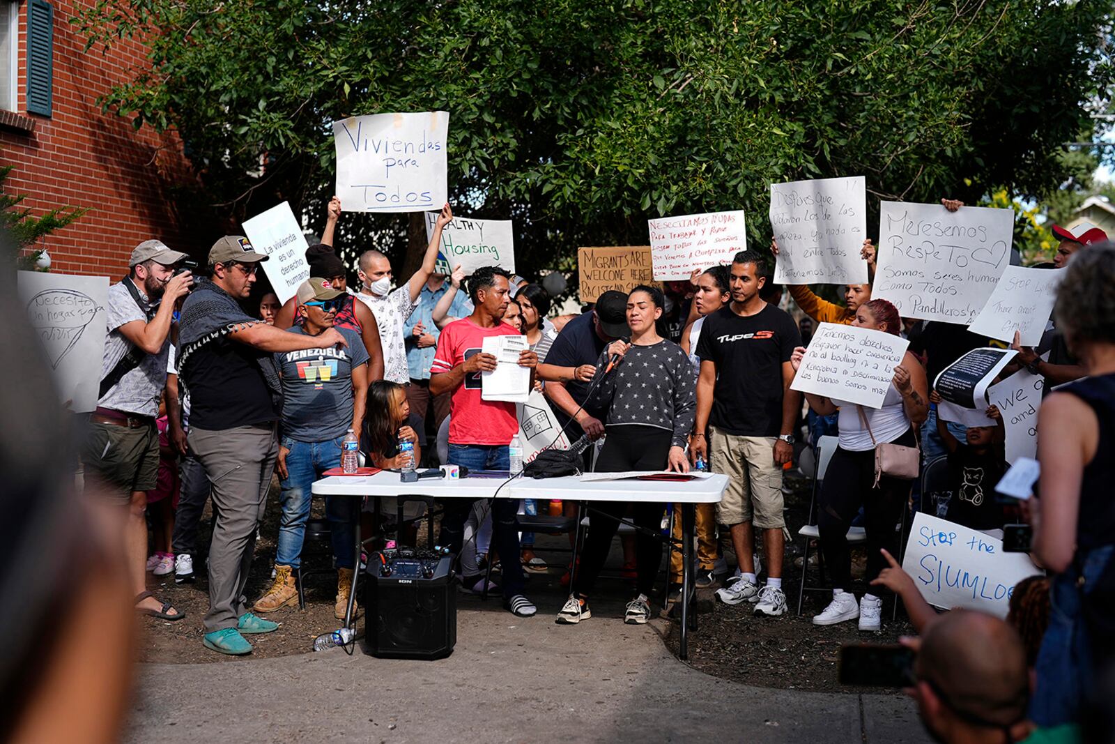 FILE - Juan Carlos Jimenez, center left, and Geraldine Massa speak during a rally by the East Colfax Community Collective to address chronic problems in the apartment buildings occupied by people displaced from their home countries in central and South America, Tuesday, Sept. 3, 2024, in Aurora, Colo. (AP Photo/David Zalubowski, File)