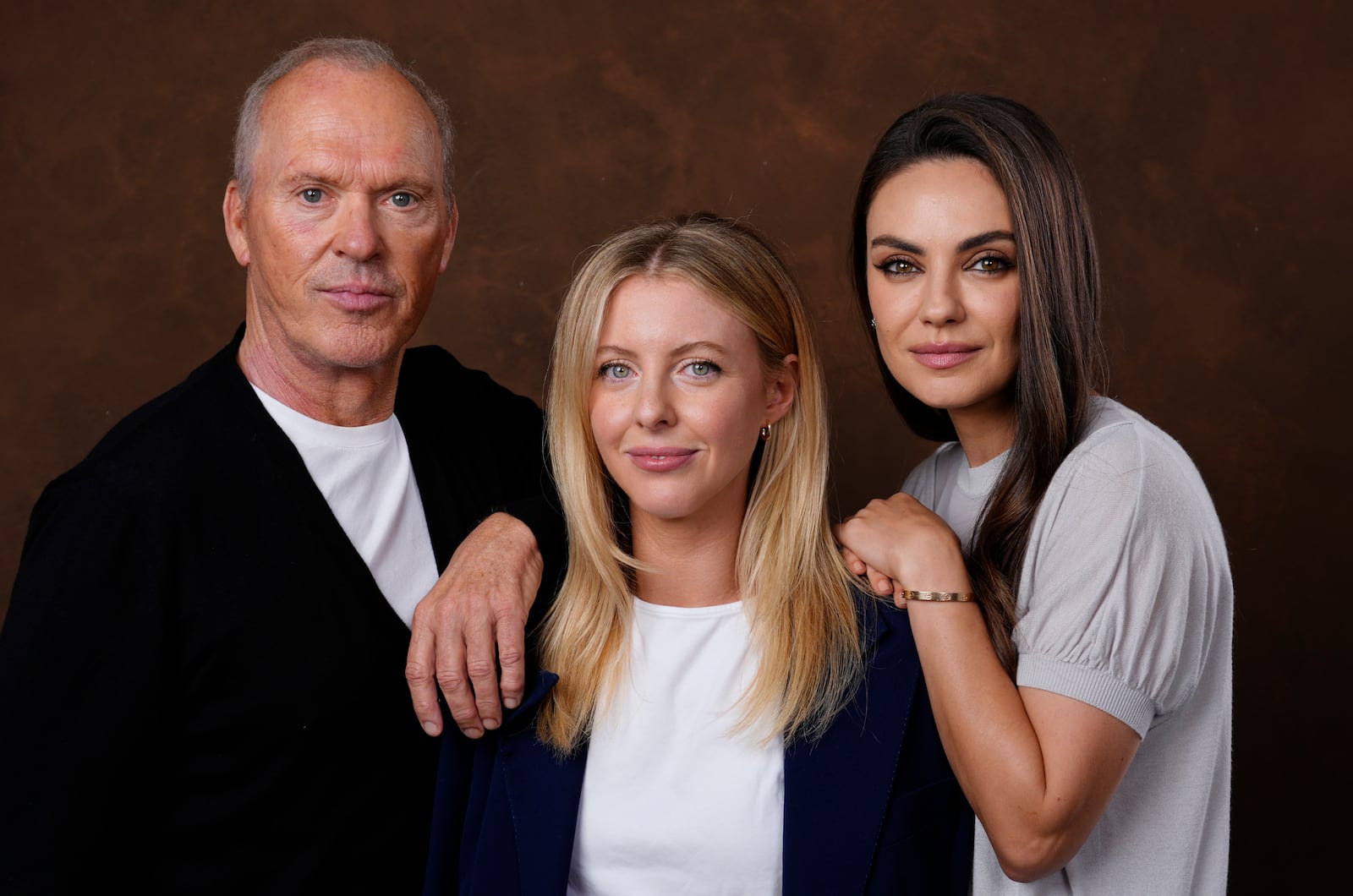 Hallie Meyers-Shyer, center, writer/director of "Goodrich," poses with cast members Michael Keaton, left, and Mila Kunis, Tuesday, Oct. 8, 2024, in Los Angeles. (AP Photo/Chris Pizzello)