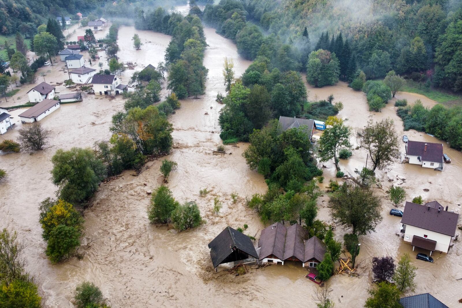 Flooded houses after a heavy rain in the village of Luke, near Bosnian town of Fojnica, 50 kms west of Sarajevo, Bosnia, Friday, Oct. 4, 2024. (AP Photo/Robert Oroz)