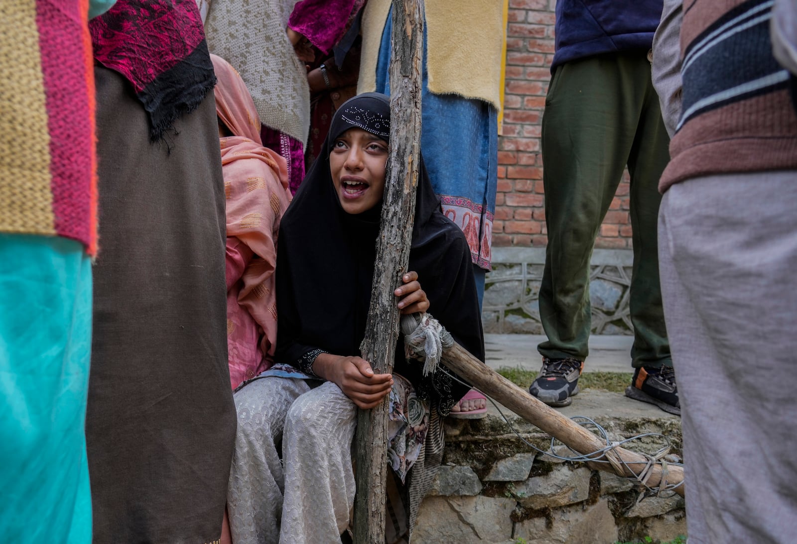 A family member cries during his funeral of Kashmiri doctor Shahnawaz who was among those killed when gunmen fired at people working on a strategic tunnel project in Indian-controlled Kashmir, at Nadigam village, southwest of Srinagar, Monday, Oct. 21, 2024. (AP Photo/Mukhtar Khan)